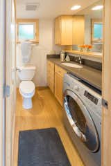 A narrow bathroom contains a 60-inch shower and tub as well as an optional washer-dryer, luxuries many apartment-dwellers only dream of owning.