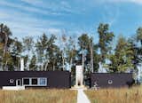 Exterior, House Building Type, Flat RoofLine, and Wood Siding Material Two Black Sheds incorporates all the conventional aspects of a weekend retreat in a rather unconventional way.  Photo 4 of 10 in Off the Beaten Path