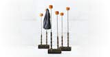 Paola Navone's Black 94 coat rack is black bamboo, stone and orange cotton pompoms. Designed for Gervasoni, the Black 94 is understated and naturally inspired, resembling freshwater reeds.