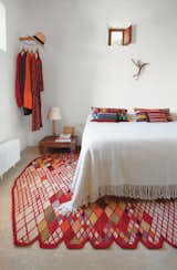 A Losanges rug by Ronan and Erwan Bouroullec, part of Marquina’s 2011 collection, anchors the simple master bedroom of Nani Marquina's vacation home on Ibiza.