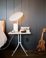 Bedroom, Night Stands, Table Lighting, and Dark Hardwood Floor More prized possessions that made the cut: A George Nelson Half-Nelson lamp sits atop an Alexander Girard bedside table.  Search “sous mon arbre lamp” from Less is More in this Manhattan Beach Bungalow
