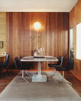 In 2005, Gretchen Rice and Kevin Farnham acquired a 1908 home in San Francisco that had been remodeled in the 1940s by well-known local architect Henry Hill. Their series of small interventions have kept the design intent of the 1940s renovation—including an enclosed atrium, wood wall paneling, and unusual built-ins—while updating the home for contemporary living. In the dining area, Metropolitan side chairs by Jeffrey Bernett for B&amp;B Italia surround a Surf Table designed by Carlo Colombo for Zanotta.