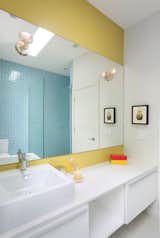 Benjamin Moore’s Mustard Field paint adds a vibrant touch to another bathroom in the house.