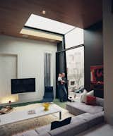 Living Room, Sectional, and Rug Floor In the living room, a double-height window and a skylight work together to frame a view of the Victorian Gothic church just across the street.  Photo 7 of 8 in Brilliant Skylights We Love by Aileen Kwun from WestEnders
