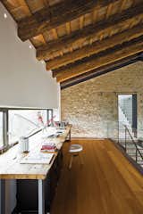 Office, Chair, and Medium Hardwood Floor “At first we thought we might not need that much space, but then we started thinking long term. We look at this house as the home of our lifetime.” —Guido Chiavelli  Photo 9 of 13 in A Renovated Farmhouse in Northern Italy