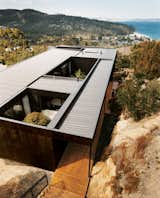 The Kingston house remains unobtrusive and well camouflaged on its hillside site despite the architects’ use of modernist geometry. The outer cladding is simply plywood stained with dark Madison oil.