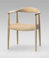 The Round Chair from 1949 is one of Wegner's most iconic pieces and a highlight of Danish design. “Round One” is minimalist art reduced to its bare essentials. It required incredible craftsmanship to create such smooth curves—each of the crescent-shaped armrests are fashioned from a block of wood, and interior mortise-and-tenons hide the connection between the arms and legs. Famously, when Kennedy and Nixon sweated it out during the first televised Presidential debate, they were both sitting on Wegner’s design. Manufactured by PP Møbler. Photo by Jens Mourits Sørensen.  Photo 2 of 8 in 7 Iconic Chairs by Hans Wegner