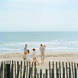 Because the ocean is so close to the house, the Fisher family treats the beach like an extended backyard.