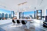Studio Dunn's Sorenthia chandelier hangs in a Vancouver office space by Julie Miller of Creative Shift Studio with contributions from Vanessa Leung of Designuud Studio, Miguel Brovhn of Studio Brovhn, and and Gail Guevara of Gail Guevara Design.