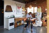 Fuscaldo and Krien found an old workbench and used the wood to create the counter around the kitchen sink. Photo by Nic Granleese.  Photo 3 of 8 in An Australian Architect's Simple Brick House With Impressive Green Roof