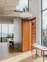 Doors, Exterior, Wood, and Swing Door Type The entrance opens into a light-filled hall, with a Marcel Wanders chandelier and a Luna console table by Noé Duchaufour-Lawrance.  Search “modern shipping container home san francisco” from A Home with Eclectic Style Looks Just Right