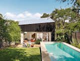 Outdoor, Back Yard, Small Pools, Tubs, Shower, and Grass Shah, Suttles, and their daughter, Tesla, use their outdoor space as an extra room. Near the pool is a seating area with Bistro chairs from Fermob.  Photo 3 of 12 in 1920s Bungalow Plus Modern Addition Equals Perfect Austin Home