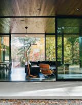 In the living room are a sectional by American Leather for Room &amp; Board, an Eames lounge chair and ottoman, and a custom floor lamp and coffee table by Jeremy Clark and Ed Haynes.
