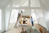 Japanese firm Mamm Design renovated this maisonette apartment in Amsterdam. Home to a family of four, the dwelling combines a series of bright, open spaces. The kitchen and bathroom, for example, are placed in this freestanding tower topped by a ladder-accessible mezzanine.