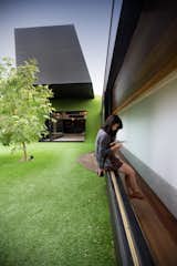 Architect Andrew Maynard designed this home in Melbourne, Australia. Called the Hill House, its form is defined by a cantilevered box that juts over an Astroturf-clad hill. A three-foot-wide corridor opens up to an expansive, open courtyard that draws sunlight into the property.