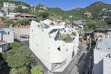 Located on a sharply sloped site in Pyeongchang-dong, a suburb of Seoul, South Korea, this home designed by Hyo Man Kim of Iroje KHM Architecture unfolds like an origami flower. Inside, secluded outdoor spaces lend sunlit interiors and privacy to the two-family dwelling housed within its faceted, asymmetrical exterior.