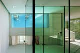 A rooftop pool extends to voyeuristic indoor views in this suburban vacation home designed by Wiel Arets in Marabella, Spain. Called the Jellyfish House, it's built almost entirely from concrete and glass.