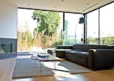 The sofa is from Cantoni, the rug is from Restoration Hardware, and the Tolomeo floor lamp is by Michele 

De Lucchi for Artemide. The large windows in the background and throughout the house are from Western Window Systems.