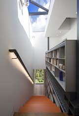 Reaching for the skylight, the five-story staircase is met at the top by the custom bookcase. The skylight opens and closes automatically in response to temperature and weather. This integrated structure is the spine of the house, off of which all other spaces are arranged.