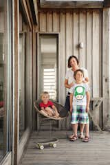 Outdoor, Wood Patio, Porch, Deck, and Small Patio, Porch, Deck Marston (on the porch with sons Eddie, left, and George) designed the new brick house to reference outbuildings on the property.  Photo 3 of 7 in Centuries-Old Farmhouses Inspired This Timeless Home