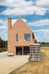 Exterior, House Building Type, Brick Siding Material, and Gable RoofLine “I wanted to do a house that belonged on the site,” she says.  Photo 5 of 7 in Modern Ways to Use Brick by Allie Weiss from Centuries-Old Farmhouses Inspired This Timeless Home