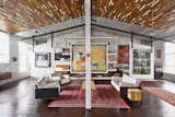 Beneath a recycled-wood ceiling and centered by a Bokhara rug, the living area contains furniture of their own design.