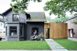 Exterior, House Building Type, Wood Siding Material, Concrete Siding Material, and Shingles Roof Material A family in Hamburg, Germany, turned a kitschy turn-of-the-century villa into a high-design home with a few exterior tricks, including sheathing the exterior in one-dimensional, murdered-out black.  Photo 7 of 15 in Renovations by Rza key from Paint it Black