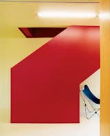 The stairwell is the bright core of the house. To keep an open feeling, and costs down, it zigzags its way up. Inexpensive metal railings are set inside and painted the same red to disappear into the stairwell.