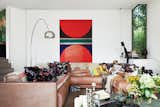 De Poorter lowered the living room floor by about three feet to allow for larger windows. Vintage Sade sofas, purchased in Berlin, join an Arco lamp by Achille Castiglioni for Flos, a Noguchi coffee table, and a painting by family friend Hugo de Clercq.