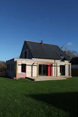A solid wood exterior retains heat in the winter and keeps the house cool in summer.  Photo 2 of 7 in A Cozy, Well-Sealed Cottage in Northwest France Goes Green