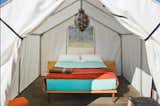 Brightly colored sheets and a central pendant lamp show this tent to its best advantage.