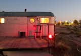 With the residents awake inside, this trailer's burnished glow reflects the sunset.
