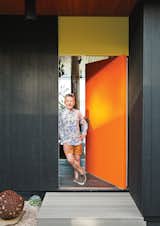 Homeowner Simon Doonan stands next to the front door.  "We have flamboyance, and we’re not inhibited about anything. [Architect] Gray Organschi gave [the house] that intellectual rigor needed to make it beautiful. We were well matched."