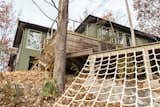 Exterior, House Building Type, Stucco Siding Material, and Wood Siding Material Another backyard hotspot is the deck, built around an existing boulder, where adults can lounge while the kids climb.  Photo 7 of 15 in How This Landscape Design Made a Home as Fun as a Playground