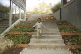 Outdoor, Concrete Patio, Porch, Deck, and Walkways  Search “part in the backyard” from How This Landscape Design Made a Home as Fun as a Playground