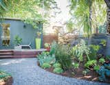 You can use lush shrubs to make your small outdoor space seem larger than it is. By effectively "hiding" parts of your yard you create a greater sense of space and movement. Plant shrubs that fill out to touch each other or move potted plants to create mini-hedges. Remember that your plants will grow – even your smaller, shorter plants will eventually grow into bigger plants. The large leaves of big tropical plants can help to change the scale of a small space to make it feel larger.