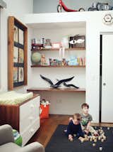 Built-in shelves and a changing table 

by Ducduc in Hawk’s room offer ample storage.
