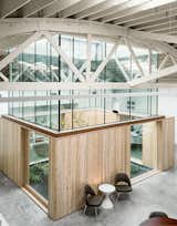 Linda Hutchins and John Montague hired Works Partnership Architecture to turn a former warehouse and auto repair shop into a versatile live/work space. The building is full of natural light, thanks to 11 skylights and a glass atrium in the center of the space, where a hammock and a vine maple tree sway in the breeze.