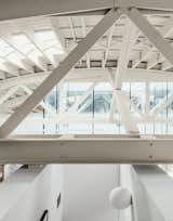 Architects William Neburka and Carrie Strickland set off some spaces with walls that stop shy of the bowstring trusses to preserve an overall sense of openness.
