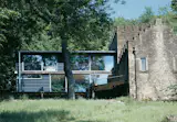 After architect Piers Taylor acquired Moonshine Cottage, a former gamekeeper's residence outside of Bath, England, he added a timber-and-glass extension that provided much-needed space as well as a striking contrast between pastoral and modern aesthetics.