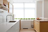 The kitchen system and rolling island are by Henrybuilt.  Photo 9 of 10 in Minimalist Dream Kitchens by Diana Budds from Luminous Modern Interiors