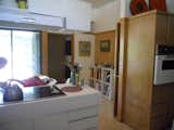 BEFORE: Without the additional lumination from the added kitchen window, the Houser home's kitchen rior to renovation is dark and incompatible with the surrounding spaces.  Photo 9 of 13 in Midcentury Renovation in Austin