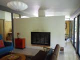 BEFORE: Looking disjointed, the living room in the pre-renovation Houser home is an alienated space, occluded from the natural light entering the spaces just beyond.  Photo 11 of 13 in Midcentury Renovation in Austin