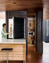 While most of the ground level is given over to the large open living and dining area, it also includes a small pantry, office, and Japanese bathroom. An integrated Sub-Zero refrigerator is almost unnoticeable behind its charred-cedar cladding.