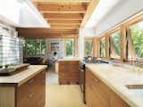 Daylight adds to the warm ambiance of the wooden millwork of the Nature Preserve House kitchen.