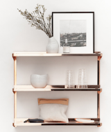 Sigurd Larsen's Click shelf is made of boltless, lacquered copper. With four screws affixing the units shelves to its girder, the unit is simply assembled, functioning seamlessly within the design scheme of a space.