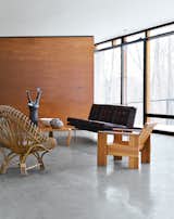 Architect William Massie built a hybrid prefab home for vintage retailer Greg Wooten, who handled the interiors. In the living room is a 1950s Franco Albini rattan chair, a Crate chair designed by Gerrit Rietveld in 1934, and a 1970s sofa by Edward Axel Roffman. The tall ceramic piece is by Bruno Gambone.