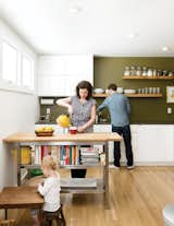 Kitchen, White Cabinet, Recessed Lighting, Light Hardwood Floor, and Open Cabinet In the kitchen, artist Riley McFerrin installed custom floating shelves.  Search “waveform shelves” from A Couple Tackles Conversion Challenges and Builds a Modern Renovation