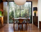 This dining room features the Cherner Chair alongside a dining room table designed by Benjamin Cherner.