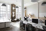 Muuto lamps draw attention to the tall ceilings. The office chairs are Herman Miller's ergonomic Aeron Chairs.  Photo 5 of 11 in Office from Scandinavian-Inspired Office Design in NYC